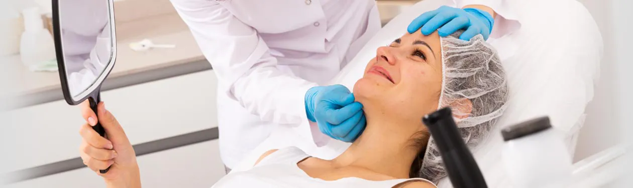 Doctor inspecting woman's face during consultation